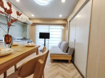 a kitchen with a table and a couch in a room at 65 \u4e24\u5ba4\u4e00\u5385 \u99d2\u8fbc\u7ad94\u5206 \u8fd1\u5546\u4e1a\u8857 2 rooms 4 mins to ST Max 7P \u76f4\u8fbe\u65b0\u5bbf \u6d89\u8c37 \u8868\u53c2\u9053 \u6c60\u888b \u4e0a\u91ce \u4ee3\u4ee3\u6728 \u94f6\u5ea7 \u539f\u5bbf in Tokyo