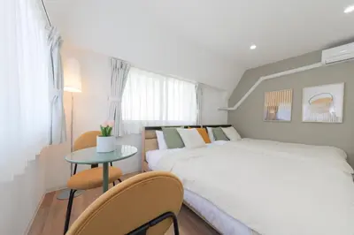 a bedroom with a large bed and a table at HOTEL Beruhigen Tokyo - Vacation STAY 93718v in Tokyo