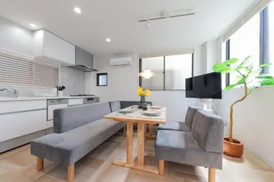 a kitchen and living room with a table and a couch at HOTEL Beruhigen Tokyo - Vacation STAY 93718v in Tokyo