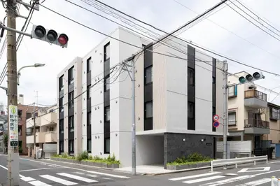 a building on a city street with a traffic light at aLATO\u5927\u68ee\u753a in Tokyo
