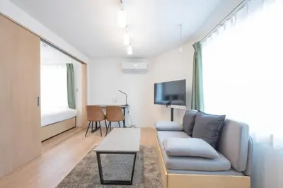 a living room with a couch and a tv at Mat\u91ce\u65b9 in Tokyo