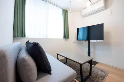 a living room with a couch and a tv at Mat\u91ce\u65b9 in Tokyo