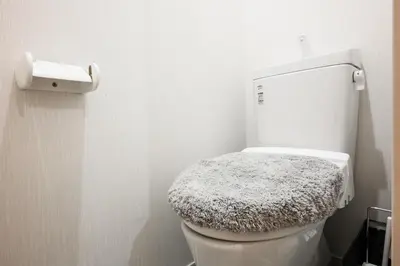 a bathroom with a white toilet with a stool on it at 3, Kameido, Entire house for rent, \u4e80\u6238 in Tokyo