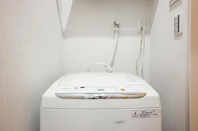 a washing machine sitting on top of a toilet in a room at 3, Kameido, Entire house for rent, \u4e80\u6238 in Tokyo