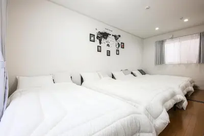 two beds in a room with white walls at 3, Kameido, Entire house for rent, \u4e80\u6238 in Tokyo