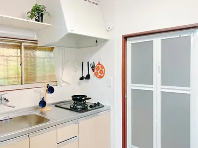 a white kitchen with a sink and a stove at Ikebukuro area, two layer house, double subway,3 min walk to stn, \u53cc\u5730\u94c1\u8f66\u7ad9\u6b65\u884c3\u5206 \u76f4\u8fbe\u65b0\u5bbf \u6da9\u8c37 \u94f6\u5ea7 \u6c60\u888b \u7687\u5c45 \u6700\u59276\u4eba in Tokyo