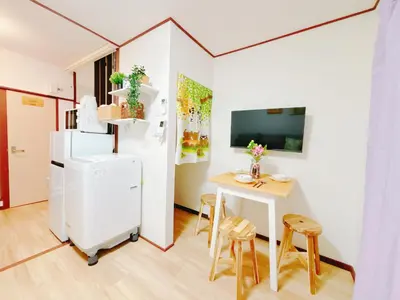 a small kitchen with a small table and a white refrigerator at Ikebukuro area, two layer house, double subway,3 min walk to stn, \u53cc\u5730\u94c1\u8f66\u7ad9\u6b65\u884c3\u5206 \u76f4\u8fbe\u65b0\u5bbf \u6da9\u8c37 \u94f6\u5ea7 \u6c60\u888b \u7687\u5c45 \u6700\u59276\u4eba in Tokyo