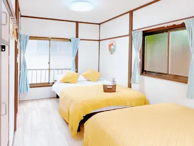 a bedroom with two beds and a window at Ikebukuro area, two layer house, double subway,3 min walk to stn, \u53cc\u5730\u94c1\u8f66\u7ad9\u6b65\u884c3\u5206 \u76f4\u8fbe\u65b0\u5bbf \u6da9\u8c37 \u94f6\u5ea7 \u6c60\u888b \u7687\u5c45 \u6700\u59276\u4eba in Tokyo