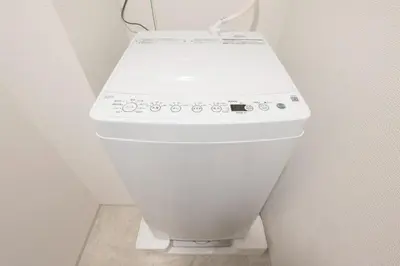 a white toilet in a corner of a bathroom at \u30a2\u30a4\u30c7\u30a3\u84b2\u7530\u897f in Tokyo