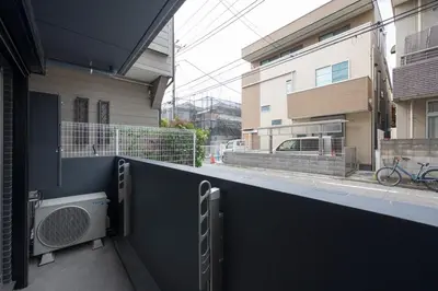 a view of a balcony of a building at \u30a2\u30a4\u30c7\u30a3\u84b2\u7530\u897f in Tokyo