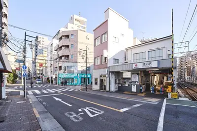 an empty street in a city with tall buildings at \u30a2\u30a4\u30c7\u30a3\u84b2\u7530\u897f in Tokyo