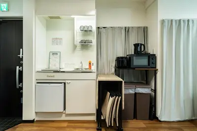 a small kitchen with a sink and a microwave at 66, Omori-Nishi, Entire house for rent, \u5927\u68ee\u897f in Tokyo