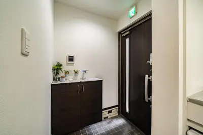 a bathroom with a sink and a black door at 66, Omori-Nishi, Entire house for rent, \u5927\u68ee\u897f in Tokyo