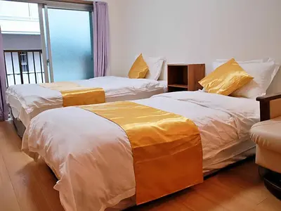 two beds in a room with a window at Mamada Building - Vacation STAY 16945 in Tokyo