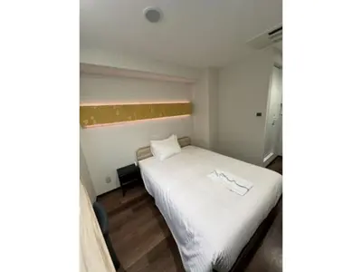 a small room with a bed with white sheets at ELE HOTEL HIGASHI NIHONBASHI - Vacation STAY 01248v in Tokyo