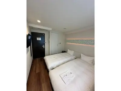 two beds in a small room with white sheets at ELE HOTEL HIGASHI NIHONBASHI - Vacation STAY 01264v in Tokyo