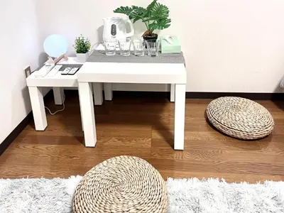 a white table with glasses and a potted plant on it at Ikebukuro Sugamo \u99c5\u8fd1 A4 in Tokyo