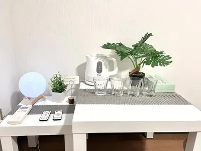 a white table with plants and glasses on it at Ikebukuro Sugamo \u99c5\u8fd1 A4 in Tokyo