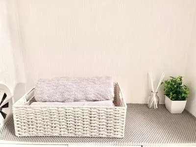 a wicker basket sitting on a floor with a plant at Ikebukuro Sugamo \u99c5\u8fd1 A4 in Tokyo