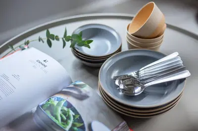 a table with plates and forks and spoons and a book at \u3077\u3075\u304b\u6771\u5411\u5cf63 in Tokyo