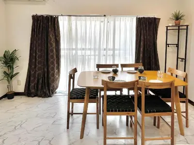 a dining room with a table and chairs and a window at \u6c60\u888b2\u5206\u6700\u592712\u4eba\u53ef in Tokyo