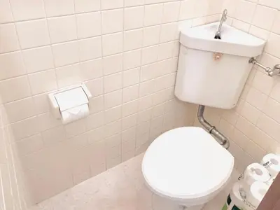 a bathroom with a white toilet and a toilet paper dispenser at \u6c60\u888b\u96fb\u8eca2\u5206 2Rooms in Tokyo