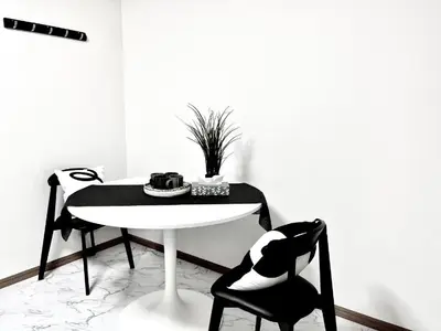a black and white room with a table and two chairs at \u6c60\u888b\u96fb\u8eca2\u5206 2Rooms in Tokyo