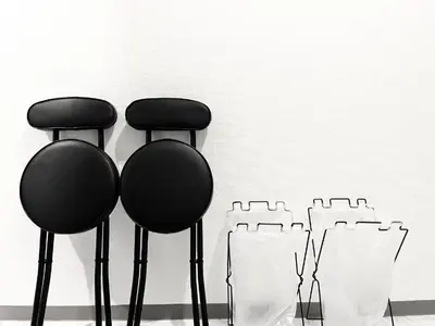 two black chairs in front of a white wall at \u6c60\u888b\u96fb\u8eca2\u5206 2Rooms in Tokyo
