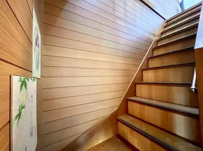 a staircase in a sauna with wooden walls at \u65b0\u5c0f\u5ca9\u9a7f\u7ad9 in Tokyo
