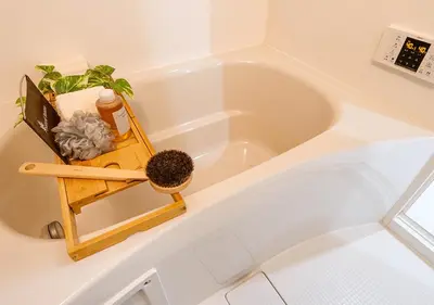 a white bath tub with a plant in it at Asakusabashi Condominium Hotel in Tokyo