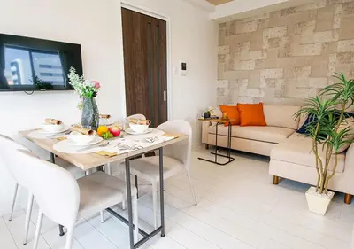 a living room with a table and a couch at Asakusabashi Condominium Hotel in Tokyo