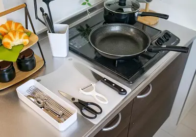 a frying pan on top of a stove in a kitchen at Asakusabashi Condominium Hotel in Tokyo