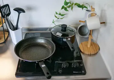 a pot on a stove with a pan on it at Asakusabashi Condominium Hotel in Tokyo