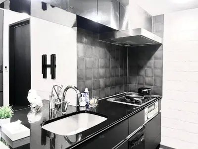 a kitchen with a sink and a stove at Shibuya Harajuku Big House in Tokyo