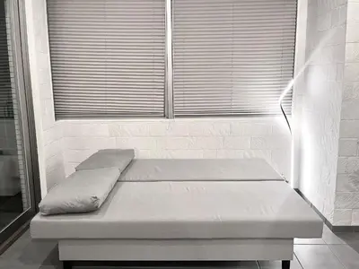 a bed sitting in a room with a window at Shibuya Harajuku Big House in Tokyo