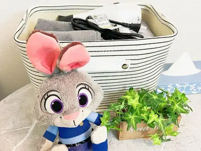 a stuffed rabbit sitting in front of a basket at \u6c60\u888b\u96fb\u8eca2\u52063Room 6\u4eba\u53ef in Tokyo