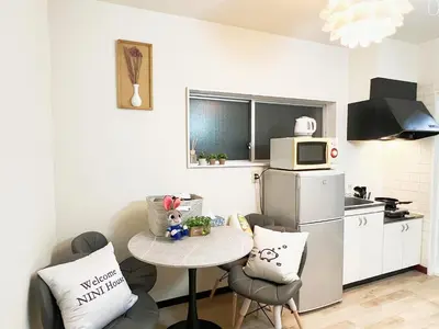 a small kitchen with a small table and a refrigerator at \u6c60\u888b\u96fb\u8eca2\u52063Room 6\u4eba\u53ef in Tokyo