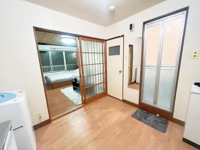 a living room with a door and a room with a sink at \u9ad8\u7530\u99ac\u58344\u5206 4\u4eba\u53ef 203 in Tokyo