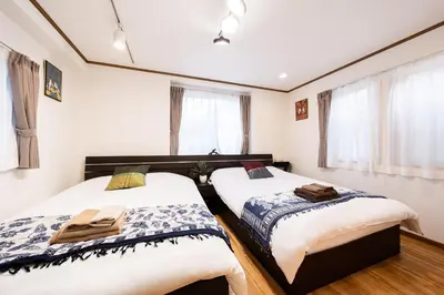 two beds in a room with white walls at 50, Nakano 1, Entire house for rent, \u4e2d\u91ce1\u4e01\u76ee in Tokyo