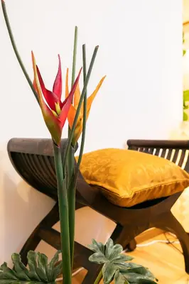 a flower in a vase on a table with a chair at 50, Nakano 1, Entire house for rent, \u4e2d\u91ce1\u4e01\u76ee in Tokyo