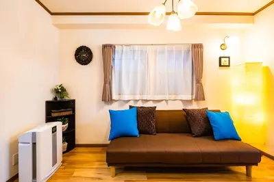 a living room with a couch and a window at 50, Nakano 1, Entire house for rent, \u4e2d\u91ce1\u4e01\u76ee in Tokyo