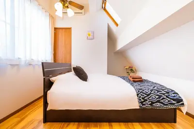 a bedroom with a bed in a attic at 50, Nakano 1, Entire house for rent, \u4e2d\u91ce1\u4e01\u76ee in Tokyo