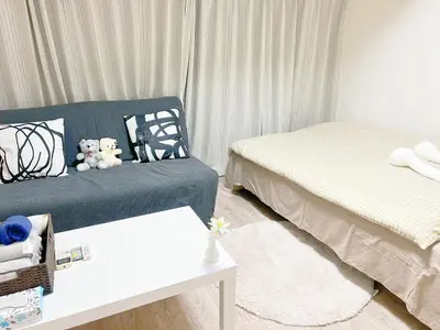a bedroom with two beds and two teddy bears at 東新宿1分&新大久保10分 in Tokyo