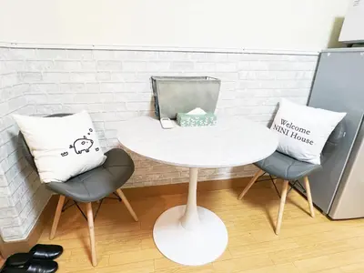 a white table with two chairs and a pillow at \u897f\u6b66\u65b0\u5bbf\u7dda\u99c5\u8fd14\u4eba\u53ef 02 in Tokyo