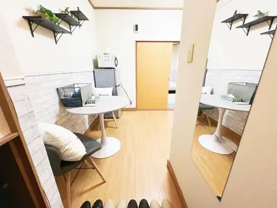 a view of a room with two tables and chairs at \u897f\u6b66\u65b0\u5bbf\u7dda\u99c5\u8fd14\u4eba\u53ef 02 in Tokyo
