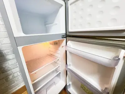 an empty refrigerator with its door open at \u897f\u6b66\u65b0\u5bbf\u7dda\u99c5\u8fd14\u4eba\u53ef 02 in Tokyo