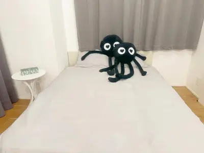 two stuffed animals sitting on top of a bed at \u6075\u6bd4\u5bff\u99c58\u52064\u4eba\u53ef in Tokyo