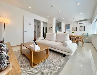 a living room with a white couch and a table at MX Hotel Roppongi in Tokyo