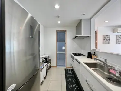 a white kitchen with a sink and a counter at MX Hotel Roppongi in Tokyo