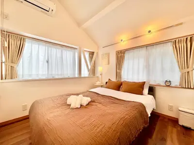 a bedroom with a bed with a stuffed animal on it at MX Hotel Roppongi in Tokyo